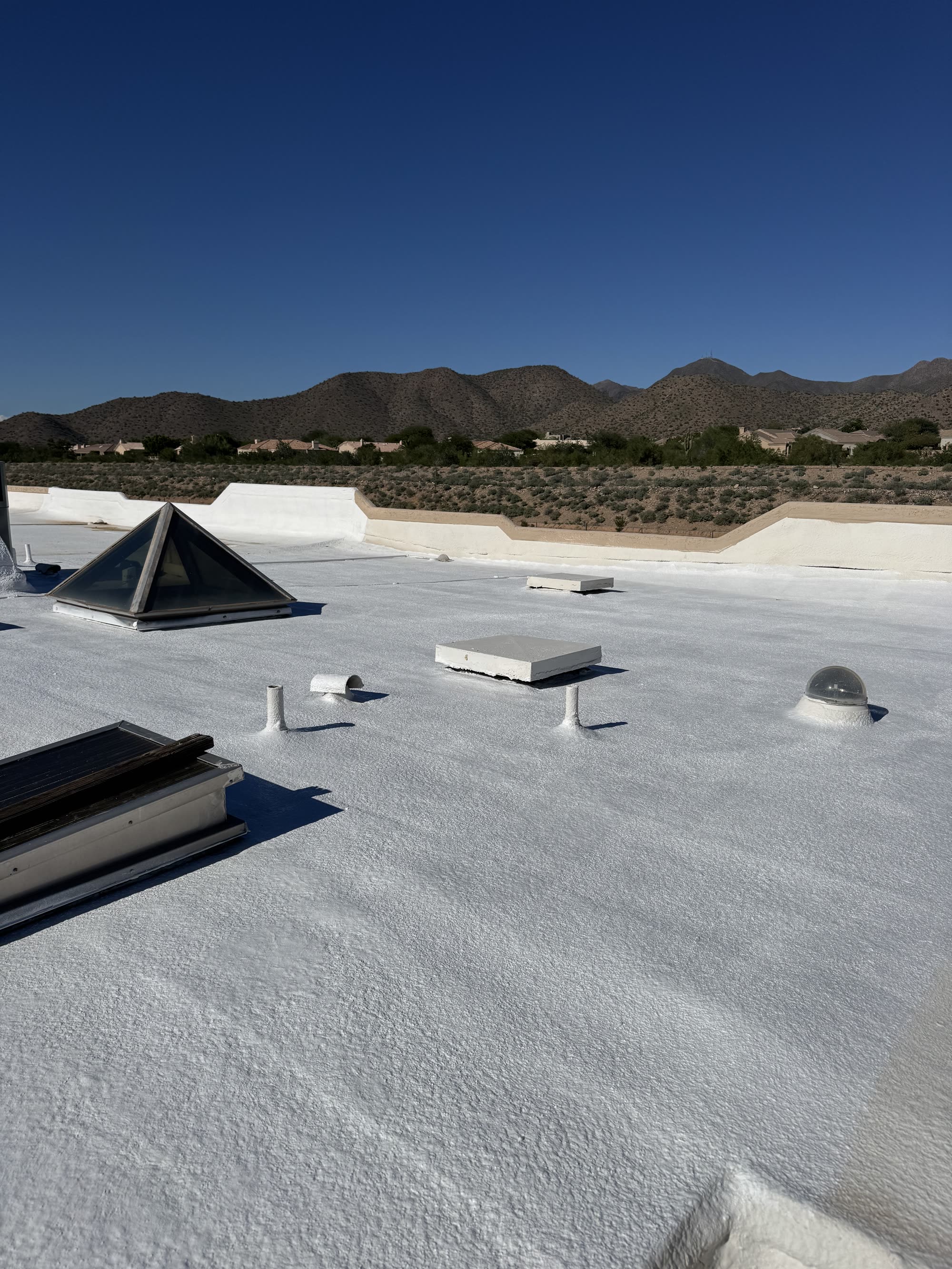White roof coating in progress