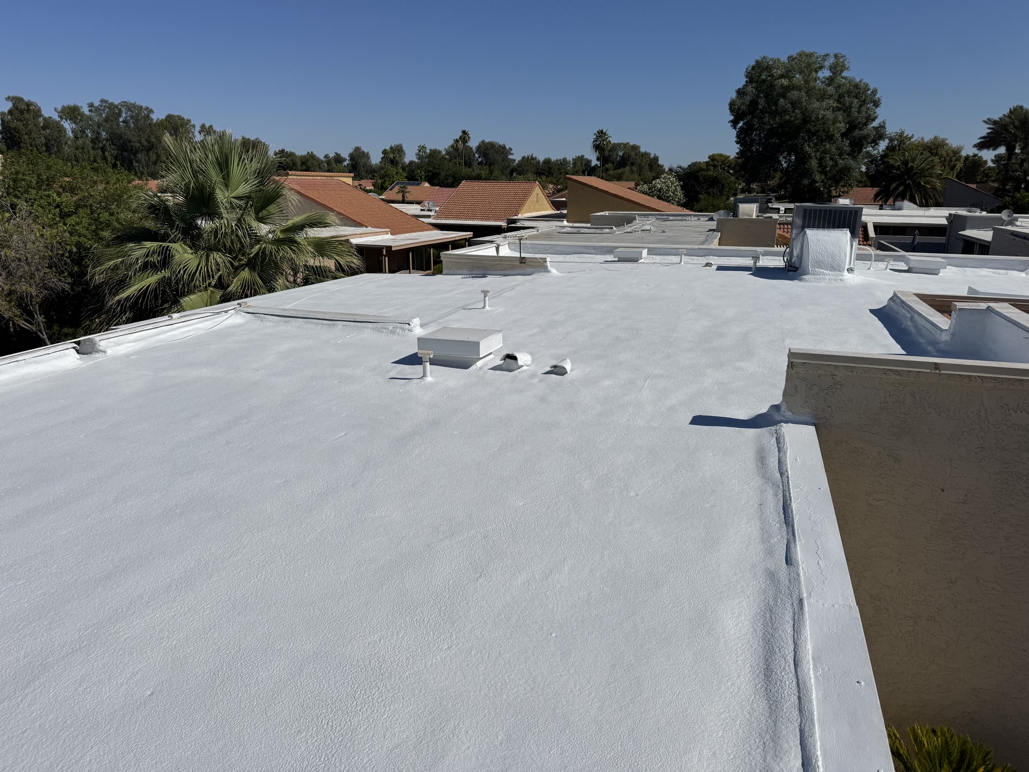 White reflective roof coating on an Arizona flat roof
