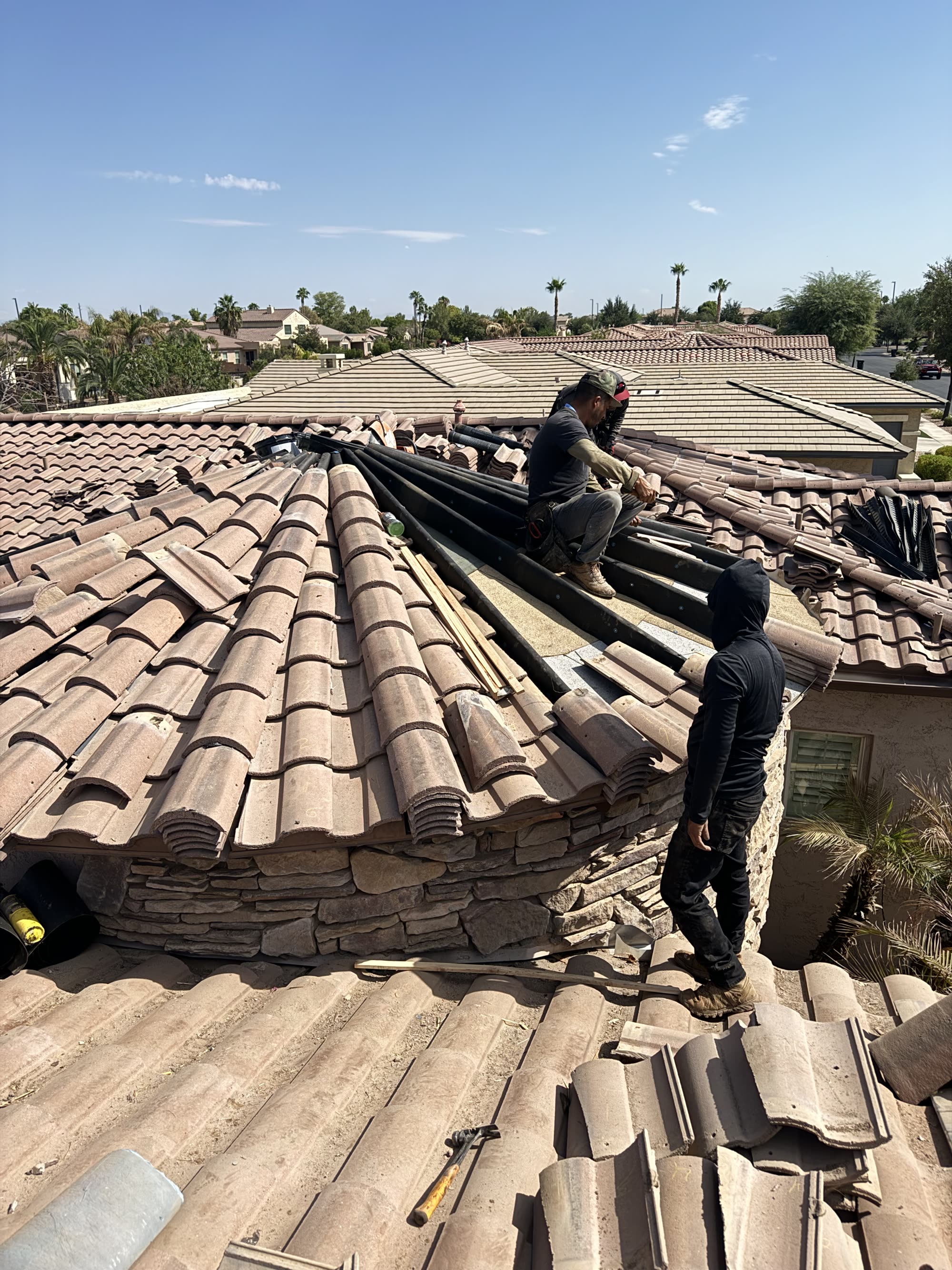 Roof repair work on an Arizona tile roof